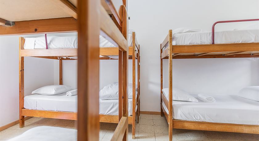 Bed in an 8-bed male dorm