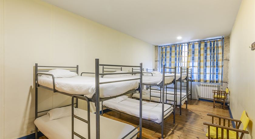 Bed in an 8-bed male dormitory